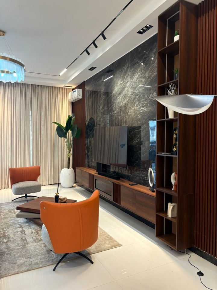 Project Brownstone living room with marble feature wall and suspended walnut media unit